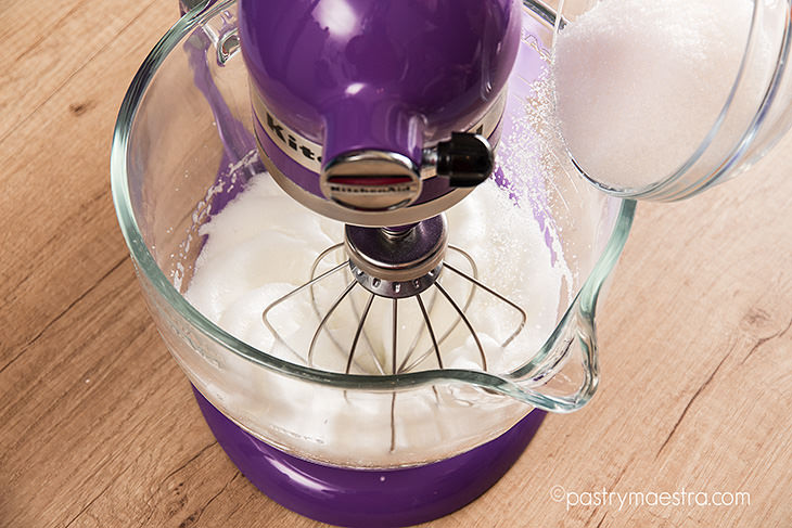 French meringue-adding sugar