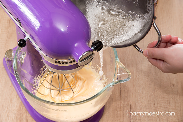 pouring-syrup-into-whipped-yolks-Pastry-Maestra-chef-Tereza-Alabanda