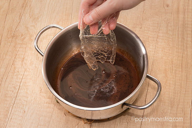 Charlotte, putting gelatin into the glaze, Pastry Maestra